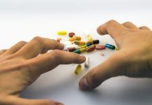 drug epidemic hands grabbing pills